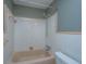 Bathroom features a beige tub with tiled shower surround at 1121 Inverness Ln, Hanahan, SC 29410