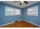 Bedroom featuring hardwood floors, two windows, and a ceiling fan at 1121 Inverness Ln, Hanahan, SC 29410