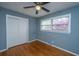 Bedroom features a ceiling fan, window overlooking blossoming trees, and a closet at 1121 Inverness Ln, Hanahan, SC 29410