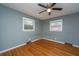 Bedroom featuring two windows, gray walls, and hardwood floors at 1121 Inverness Ln, Hanahan, SC 29410