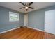 Bedroom with a ceiling fan, gray walls, hardwood floors, and a window at 1121 Inverness Ln, Hanahan, SC 29410