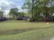 Charming one-story brick home with a spacious front yard and blooming azaleas at 1121 Inverness Ln, Hanahan, SC 29410