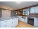 Updated kitchen with granite countertops, stainless steel sink, white cabinetry, and updated lighting at 1121 Inverness Ln, Hanahan, SC 29410