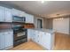 Updated kitchen features granite countertops, stainless steel appliances, and a center island at 1121 Inverness Ln, Hanahan, SC 29410