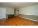 Bright living room featuring original hardwood floors, a small bench, and natural light at 1121 Inverness Ln, Hanahan, SC 29410