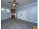Cozy living room features a brick fireplace, carpet floors and natural light at 1121 Inverness Ln, Hanahan, SC 29410