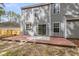 A gray two-story house featuring a brick patio and a backyard at 1158 Peninsula Cove Dr, Charleston, SC 29492