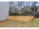 A fenced-in backyard with a freshly cut lawn and views of the neighboring trees at 1158 Peninsula Cove Dr, Charleston, SC 29492