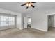 Spacious bedroom with neutral carpet, ceiling fan and entrance to bathroom at 1158 Peninsula Cove Dr, Charleston, SC 29492