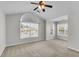 Bright bedroom featuring large windows, neutral paint, and a ceiling fan at 1158 Peninsula Cove Dr, Charleston, SC 29492