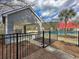 A black fence surrounds the pool area that has a red roofed pavilion at 1158 Peninsula Cove Dr, Charleston, SC 29492