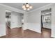 Spacious dining area featuring wood-look floors, stylish lighting, and easy access to the kitchen at 1158 Peninsula Cove Dr, Charleston, SC 29492