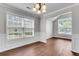 Bright dining room with large windows, wood-look floors, and elegant wainscoting at 1158 Peninsula Cove Dr, Charleston, SC 29492