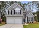 Charming two-story home boasts a well-manicured lawn, attached two-car garage, and classic architectural details at 1158 Peninsula Cove Dr, Charleston, SC 29492