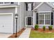 Charming home exterior with black shutters, updated lighting, and manicured landscaping at 1158 Peninsula Cove Dr, Charleston, SC 29492