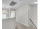 Upstairs hallway featuring a decorative chandelier and natural light at 1158 Peninsula Cove Dr, Charleston, SC 29492