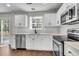Stylish kitchen featuring sleek stainless steel appliances, light countertops, and abundant natural light at 1158 Peninsula Cove Dr, Charleston, SC 29492
