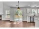 Bright and airy living space with sliding door access to backyard, fireplace, and open access to kitchen at 1158 Peninsula Cove Dr, Charleston, SC 29492