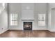 Living room featuring a fireplace with many windows and hardwood floors at 1158 Peninsula Cove Dr, Charleston, SC 29492