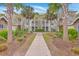 Charming condo community featuring lush landscaping, palm trees, and multiple levels with private balconies at 1300 Park West Blvd # 517, Mount Pleasant, SC 29466
