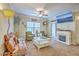 Cozy living room with a fireplace, comfortable seating, and a ceiling fan at 1300 Park West Blvd # 517, Mount Pleasant, SC 29466