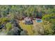 Aerial view of lush landscape, pool, driveway, and manicured lawn at 1300 S Main St, Summerville, SC 29483