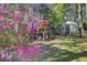 Beautiful backyard featuring a chicken coop and pink flowers at 1300 S Main St, Summerville, SC 29483