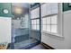 Bathroom featuring a glass-enclosed shower with subway tile and a window at 1300 S Main St, Summerville, SC 29483
