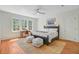Bright bedroom boasts three windows and a desk with a chair, a ceiling fan and area rug at 1300 S Main St, Summerville, SC 29483