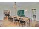 Charming dining area with chandelier, hardwood floors, and views into other living areas at 1300 S Main St, Summerville, SC 29483