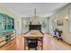 Bright dining room features hardwood floors, fireplace, chandelier, and large windows at 1300 S Main St, Summerville, SC 29483