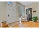 Cozy entryway with natural light, patterned chair, and hardwood floors at 1300 S Main St, Summerville, SC 29483