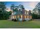 Beautiful two-story house with well-maintained lawn and mature trees at dusk at 1300 S Main St, Summerville, SC 29483