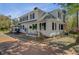 Exterior view of a two-story home with black shutters, a brick pathway, and a manicured lawn at 1300 S Main St, Summerville, SC 29483
