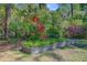 A raised garden bed is surrounded by greenery and wildflowers at 1300 S Main St, Summerville, SC 29483