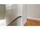 Hallway featuring a wooden railing, white trim and hardwood floors at 1300 S Main St, Summerville, SC 29483