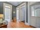 Hallway with hardwood floors, white trim, and doors leading to other rooms at 1300 S Main St, Summerville, SC 29483