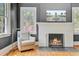 Cozy living room with a fireplace, comfortable chair, and natural light from the windows at 1300 S Main St, Summerville, SC 29483