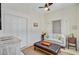 Cozy living room featuring a plush couch, stylish ottoman, and a ceiling fan for added comfort at 1300 S Main St, Summerville, SC 29483