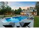 Lush backyard with a pristine pool, lounge area, and manicured lawn at 1300 S Main St, Summerville, SC 29483