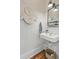 Powder room with a pedestal sink, decorative plates and a black framed mirror at 1300 S Main St, Summerville, SC 29483