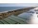 Breathtaking aerial view of coastal homes with private docks leading to the ocean, blending luxury and natural beauty at 1504 Forrest Ave, Folly Beach, SC 29439