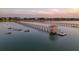 Breathtaking aerial view showcasing multiple docks extending into the waterway at sunset at 1504 Forrest Ave, Folly Beach, SC 29439