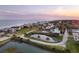 Scenic aerial view of waterfront homes, a charming pond, and the ocean in the distance at 1504 Forrest Ave, Folly Beach, SC 29439