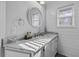 Clean bathroom featuring marble countertops, white cabinetry, and natural light at 1504 Forrest Ave, Folly Beach, SC 29439