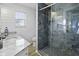Beautiful bathroom featuring modern tiles, a glass shower, and a marble countertop with a sink at 1504 Forrest Ave, Folly Beach, SC 29439