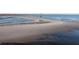 Expansive beach view with blue ocean water and a lighthouse far off in the distance at 1504 Forrest Ave, Folly Beach, SC 29439