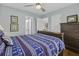 Cozy bedroom features ceiling fan, dresser, and nautical-themed bedding at 1504 Forrest Ave, Folly Beach, SC 29439