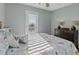 Comfortable bedroom featuring a bed with a floral quilt, a dresser, and a door to the exterior at 1504 Forrest Ave, Folly Beach, SC 29439