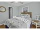 Bright bedroom with a nautical-themed queen bed, a ceiling fan, and a window at 1504 Forrest Ave, Folly Beach, SC 29439